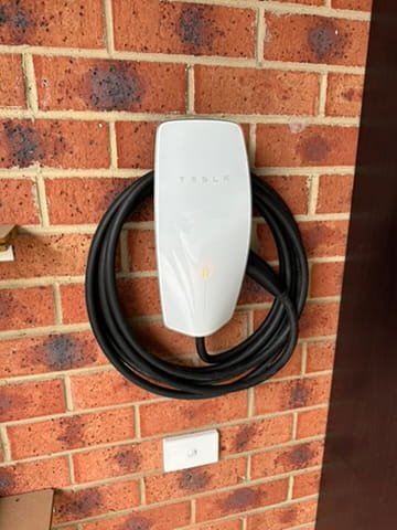 Tesla EV charger wall unit installed on brick wall, Officer VIC. Pro Fit Electrics.